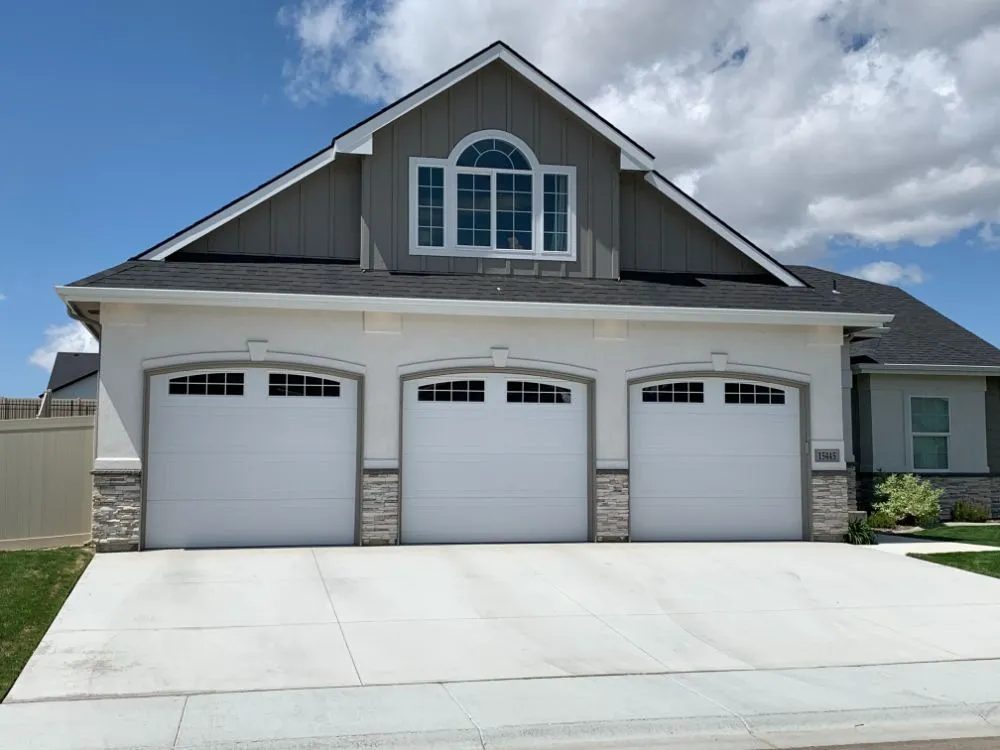 Modern flush garage door in glass and zinc